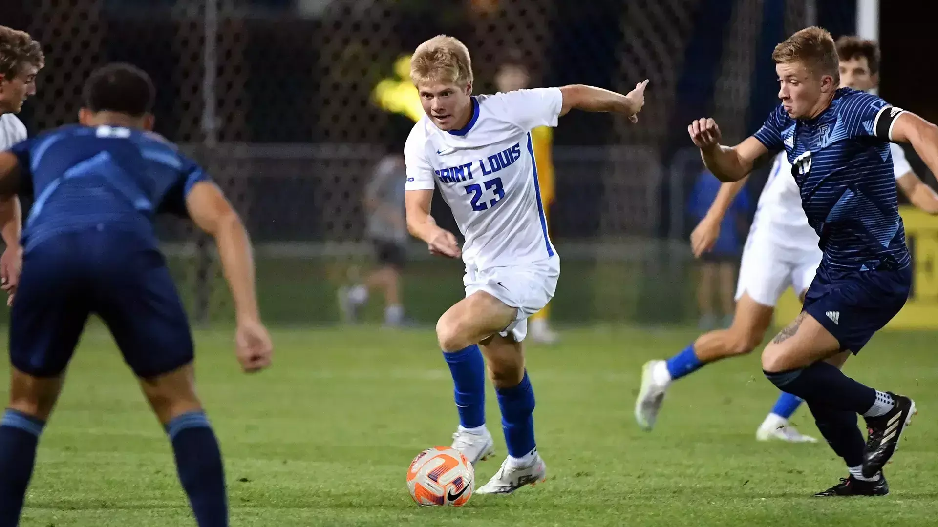 Tanner Anderson dribbling during a Saint Louis University match